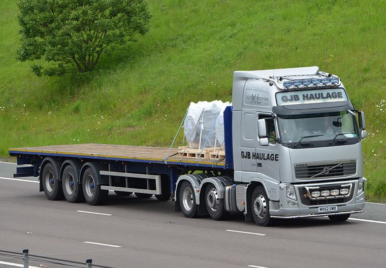 44t lorry towing a flatbed trailer