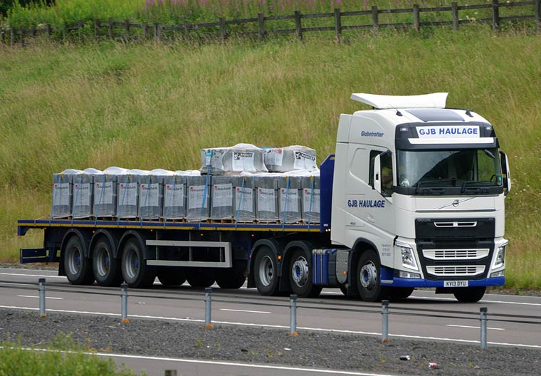 44t lorry towing a flatbed trailer
